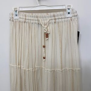 SKIRT. Long cream colored skirt with golden pin stripes.
